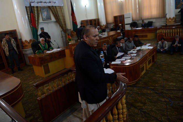 Former Chairman of Afghanistan's Kabul Bank, Sher Khan Farnoud (centre) speaks at a court in Kabul on March 5, 2013. The Afghan court sentenced 20 people, including Farnoud, for their roles in a staggering $900 million fraud that caused the country's largest bank to collapse in 2010