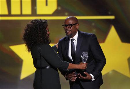 Oprah Winfrey presents the Joel Siegel award to Forest Whitaker at the 19th annual Critics' Choice Movie Awards in Santa Monica, California January 16, 2014. REUTERS/Mario Anzuoni