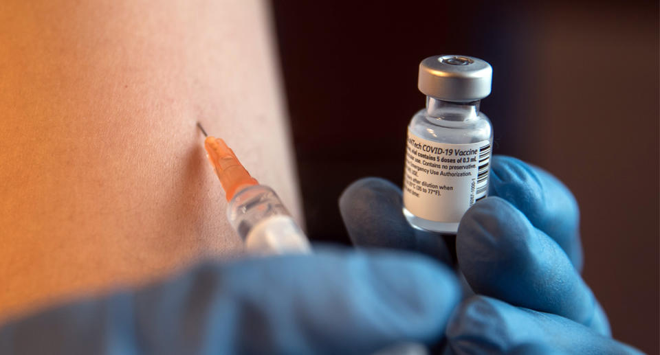 Person being injected with the Pfizer vaccine.