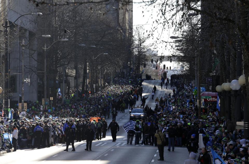 Seattle Seahawks fans line the street during the Super Bowl champions parade on Wednesday, Feb. 5, 2014, in Seattle. The Seahawks beat the Denver Broncos 43-8 in NFL football's Super Bowl XLVIII on Sunday. (AP Photo/Ted S. Warren)