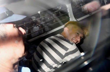 Satoshi Uematsu, suspected of a deadly attack at a facility for the disabled, is seen inside a police car as he is taken to prosecutors, at Tsukui police station in Sagamihara, Kanagawa prefecture, Japan, in this photo taken by Kyodo July 27, 2016. Mandatory credit Kyodo/via REUTERS