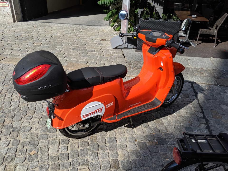 The Emmy electric scooter app is powered by Wunder Mobility. A user unlocks the scooter with an app and there's a helmet inside. (Yahoo Finance)