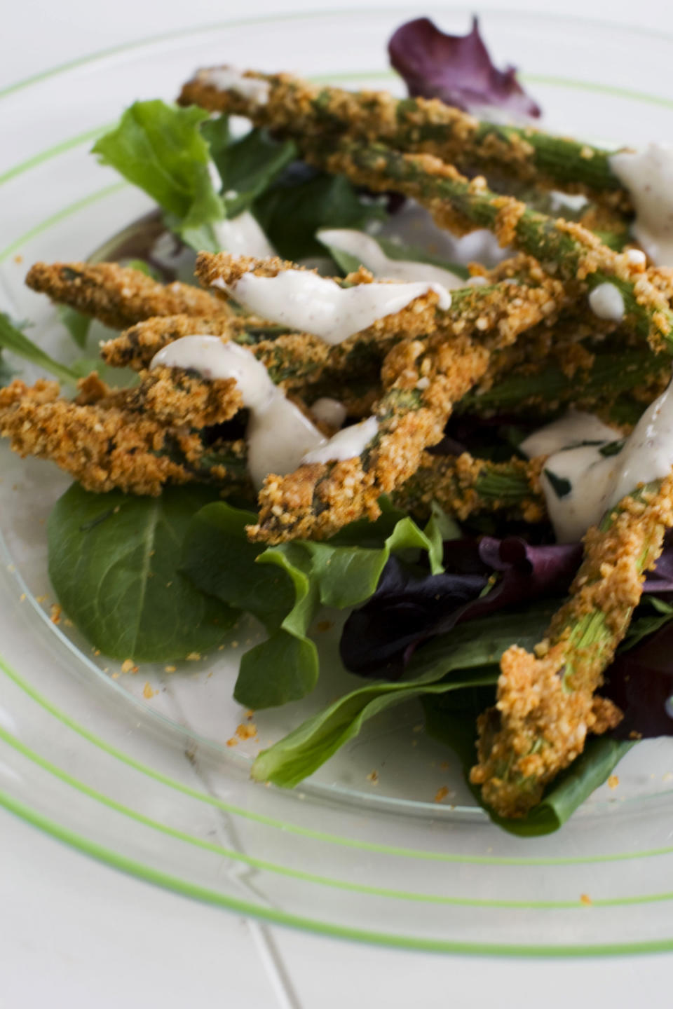 In this image taken on March 11, 2013, almond-crusted bake-fried asparagus is shown served on a plate in Concord, N.H. (AP Photo/Matthew Mead)