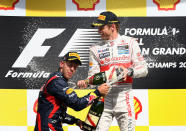 SPA, BELGIUM - SEPTEMBER 02: Race winner Jenson Button (R) of Great Britain and McLaren celebrates on the podium with second placed Sebastian Vettel (L) of Germany and Red Bull Racing following the the Belgian Grand Prix at the Circuit of Spa Francorchamps on September 2, 2012 in Spa Francorchamps, Belgium. (Photo by Clive Mason/Getty Images)