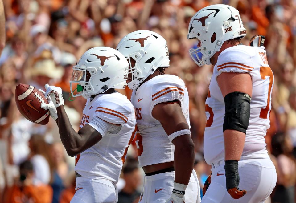 Texas wide receiver Xavier Worthy, left, celebrates after catching a touchdown pass during the Longhorns' 49-0 win over Oklahoma at the Cotton Bowl last season. Worthy has produced 122 catches for 1,741 yards and 21 touchdowns in his first 25 career starts.
