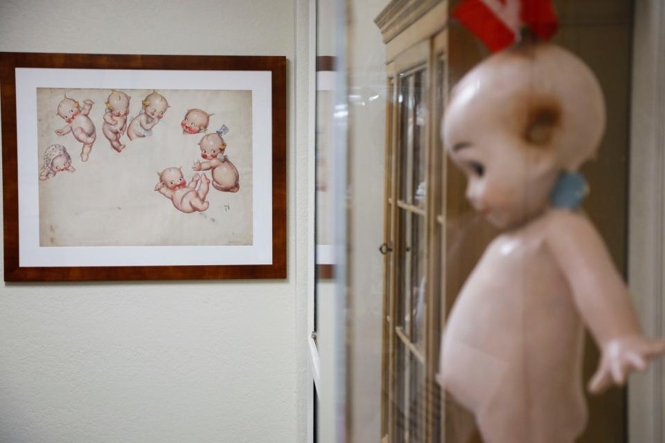 A Kewpie drawing near an original Kewpie doll at the Bonniebrook Art Gallery and Kewpie Museum on Wednesday, Sept. 6, 2023.