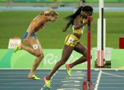 2016 Rio Olympics - Athletics - Final - Women's 200m Final - Olympic Stadium - Rio de Janeiro, Brazil - 17/08/2016. Elaine Thompson (JAM) of Jamaica crosses the finish line to win the gold. REUTERS/Gonzalo Fuentes