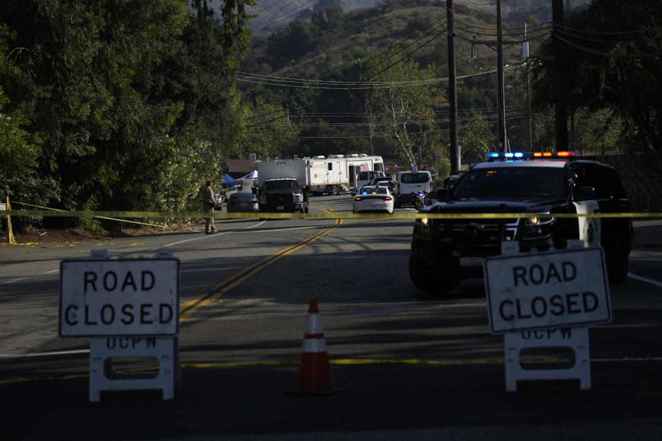 CAPTION CORRECTION: CORRECTS NAME OF BAR: Road closure signs are place at the scene of a mass shooting at Cook's Corner, Thursday, Aug. 24, 2023, in Trabuco Canyon, Calif. Gunfire at a popular Southern California biker bar killed three people and wounded several others Wednesday, and the gunman — believed to be a retired law enforcement officer — was fatally shot by deputies, authorities said. (AP Photo/Jae C. Hong)