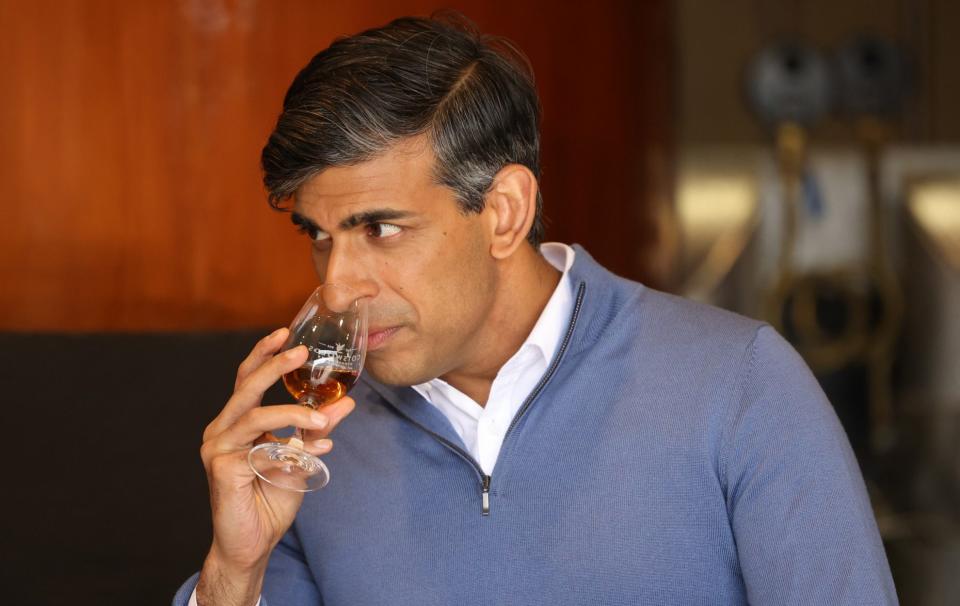 Rishi Sunak sniffs a single malt whisky at Cotswolds Distillery near Shipston-on-Stour, Warwickshire