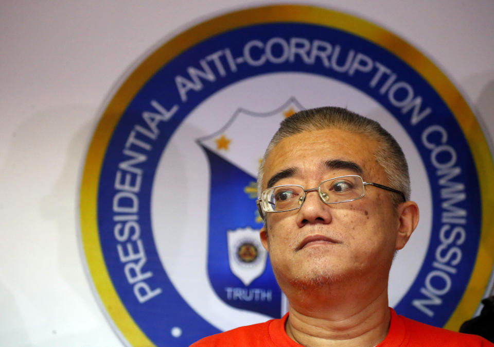 Xie Haojie, who was arrested in Manila in an operation coordinated with Chinese authorities, is presented to the media at a news conference in Manila, Philippines Wednesday, Jan. 16, 2019. Philippine officials have turned over to China the former government official wanted for alleged economic crime and corruption. (AP Photo/Bullit Marquez)