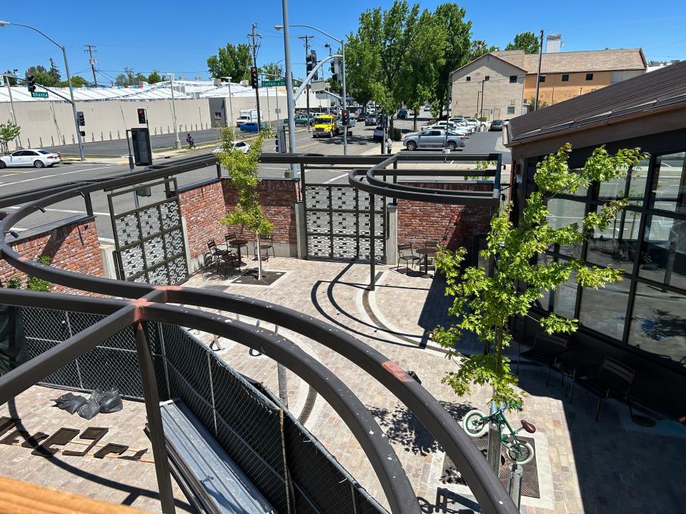The second-floor patio at Pipeline looks down on the courtyard at the Shasta Bike Depot in downtown Redding. Pipeline Redding will open in the fall of 2024.