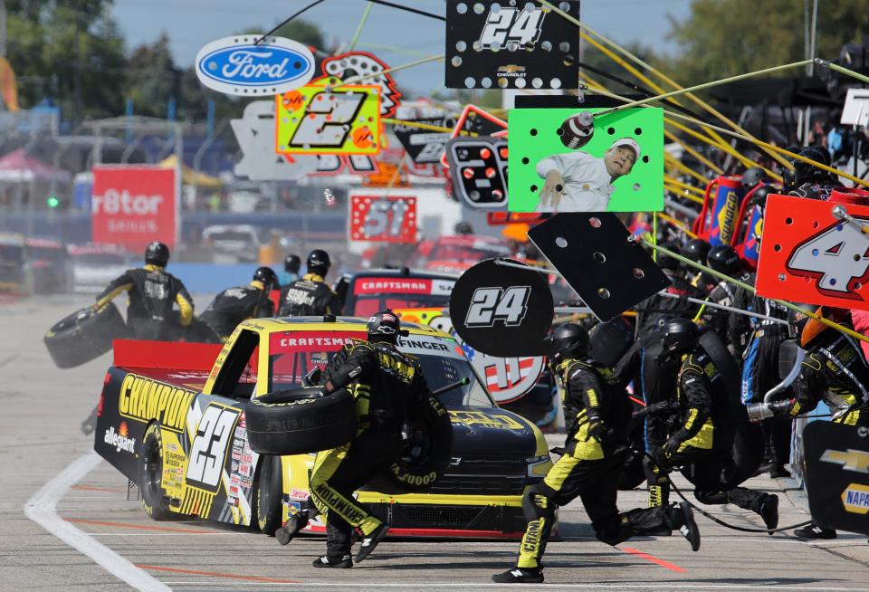 The pit crew of the Grant Enfinger leaps into action during the NASCAR Craftsman Truck Series Clean Harbors 175 on Sunday at the Milwaukee Mile.