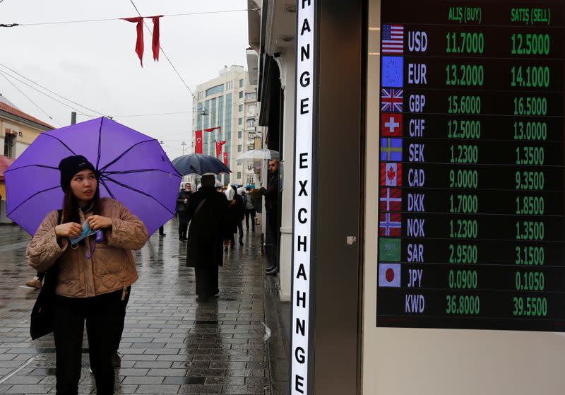 A customer stands outside a currency exchange office in Istanbul