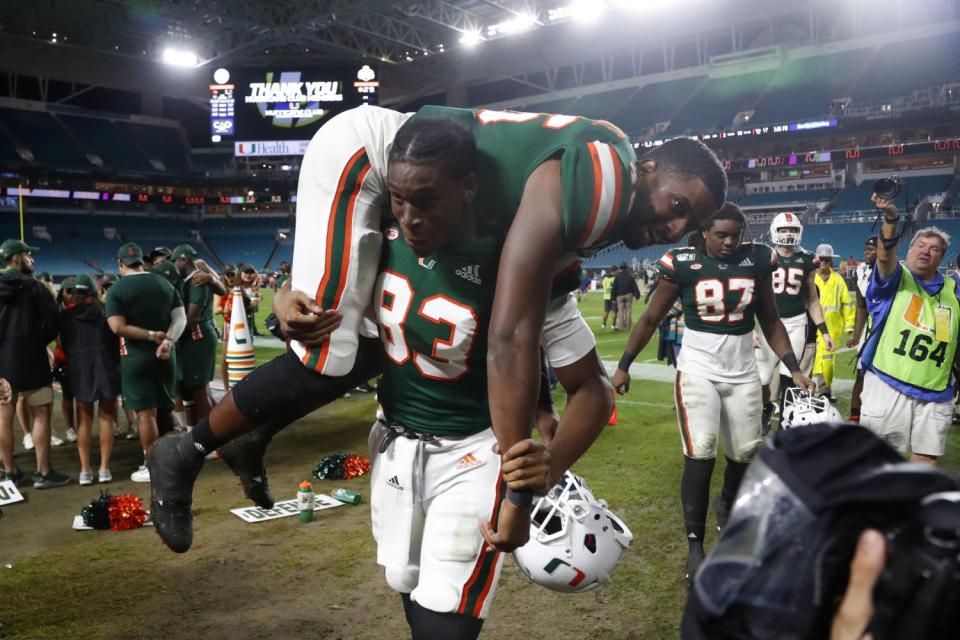 Evidence Njoku carries Nicholas Ducheine over his shoulders on the sidelines.