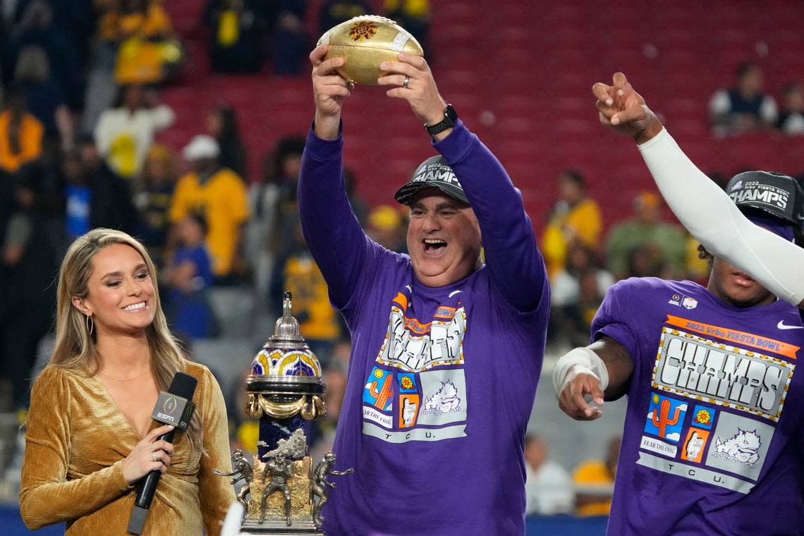 TCU head coach Sonny Dykes holds the trophy after the Fiesta Bowl NCAA college football semifinal playoff game, Saturday, Dec. 31, 2022, in Glendale, Ariz. TCU defeated Michigan 51-45. (AP Photo/Rick Scuteri)