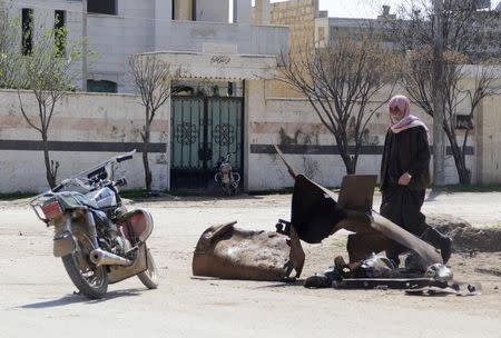 A man inspects a site targeted by what activists said was a poison gas attack in the village of Sarmin in Idlib province March 17, 2015. REUTERS/Mohamad Bayoush