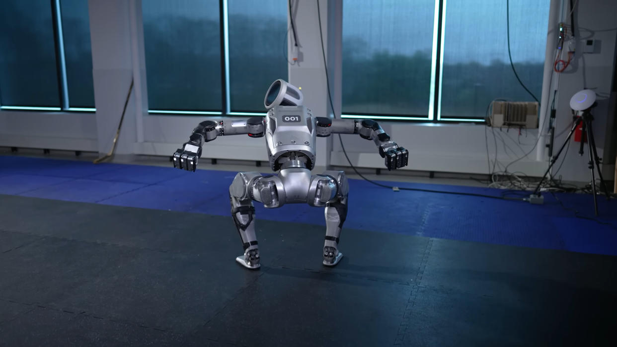  A screenshot of a video showing the new version of the Boston Dynamics Atlas robot, rising upwards in menacing fashion. 