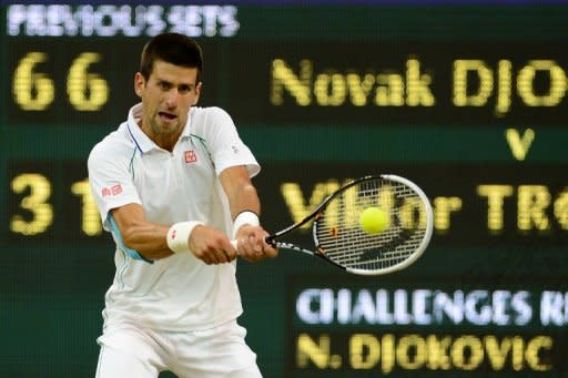 Serbia's Novak Djokovic plays a double-handed backhand shot during his fourth round men's singles victory over compatriot Viktor Troicki on day seven of the 2012 Wimbledon Championships at the All England Tennis Club in Wimbledon, southwest London, on July 2. The defending champion needed just 90 minutes to defeat Troicki 6-3, 6-1, 6-3