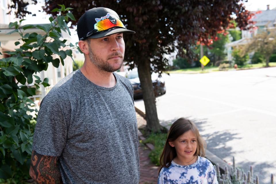 Smithsburg residents Gabriel Boumel, and his daughter, Natalie Boumel, 8, give their reactions to the Columbia Machine shooting while stopping by the downtown area on Friday, June 10, 2022. 