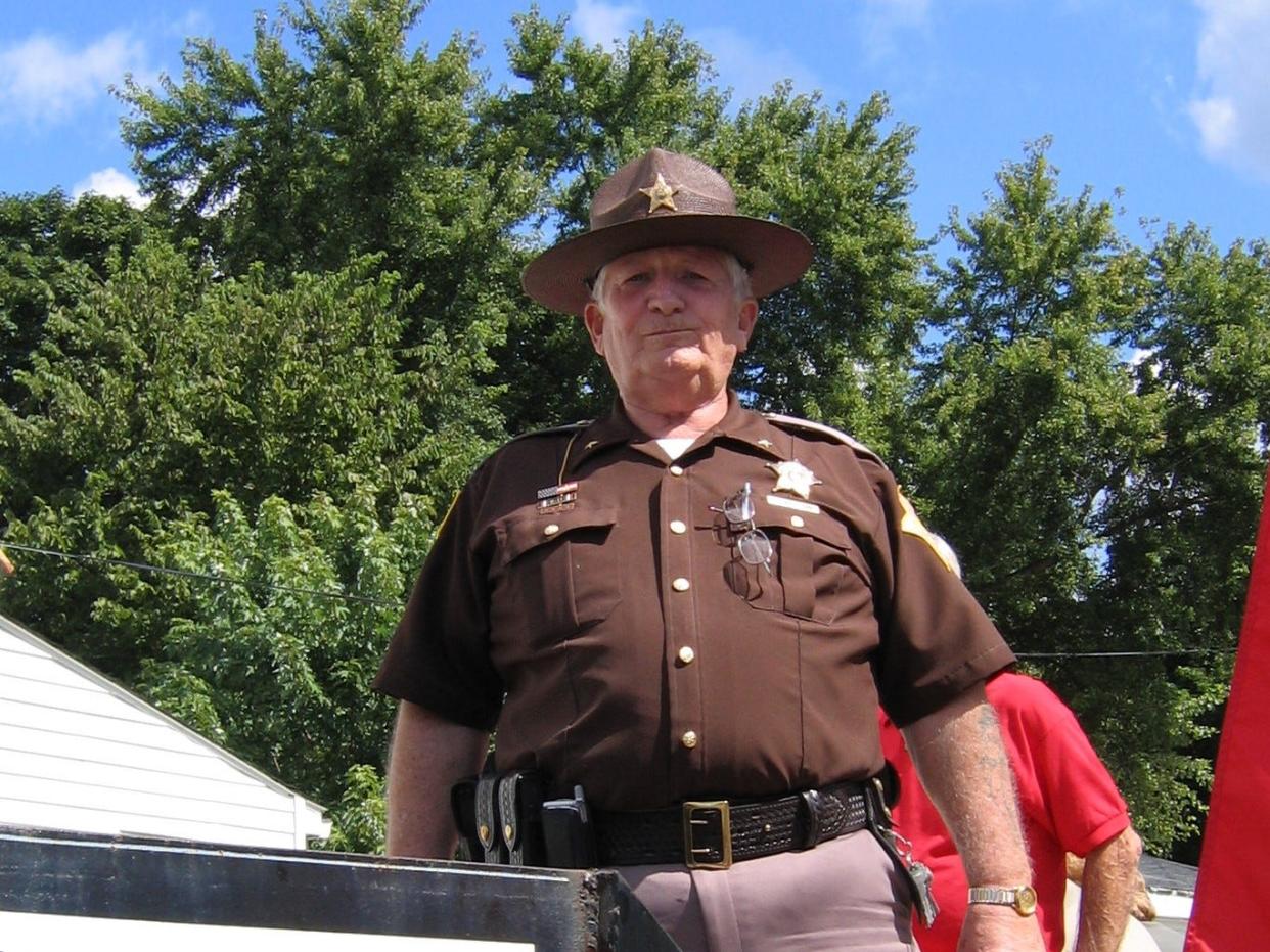 Proud of his community, Melton poses for a photo while serving as the Sheriff of Owen County.