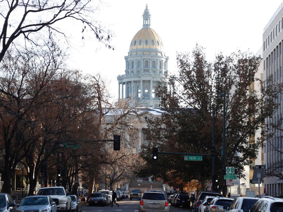 the Colorado State Capitol building stands at the base of Grant Street in downtown Denver.