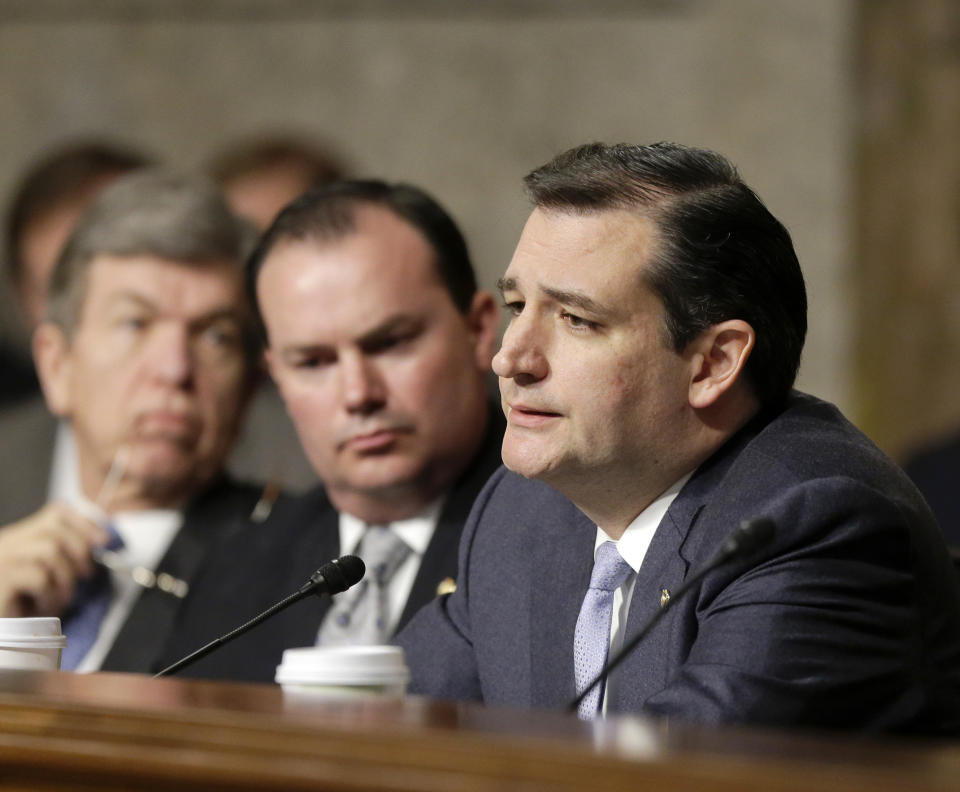 FILE - In this Jan. 31, 2013 file photo Armed Services committee member, Republican Sen. Ted Cruz (R-Texas), questions former Sen. Chuck Hagel (R-Neb.), President Barack Obama's choice for defense secretary, during Hagel's confirmation hearing on Capitol Hill in Washington. Weeks into his job, Texas Republicans are cheering Cruz's indelicate debut and embracing him as one of their own. The insurgent Republican elected with the tea party's blessing and bankroll, has run afoul of GOP mainstays, and prompted Democrats to compare his style to McCarthyism. Also seen from left are Sen.s Roy Blunt, R-Mo., and Mike Lee, R-Utah. (AP Photo/J. Scott Applewhite, File)