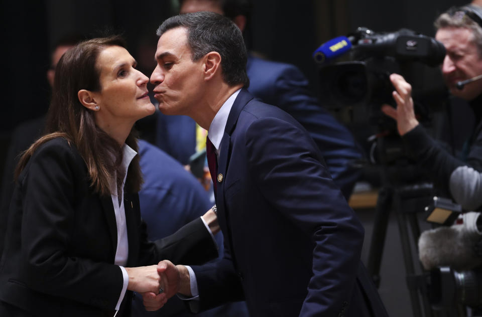 Spanish Prime Minister Pedro Sanchez, center, greets Belgian Prime Minister Sophie Wilmes, left, during a round table meeting at an EU summit in Brussels, Thursday, Dec. 12, 2019. European Union leaders gather for their year-end summit and will discuss climate change funding, the departure of the UK from the bloc and their next 7-year budget. (AP Photo/Francisco Seco)