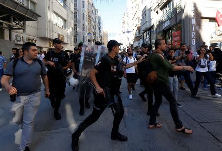 Riot police disperse LGBT rights activists as they try to gather for a pride parade, which was banned by the governorship, in central Istanbul, Turkey, June 25, 2017. REUTERS/Murad Sezer