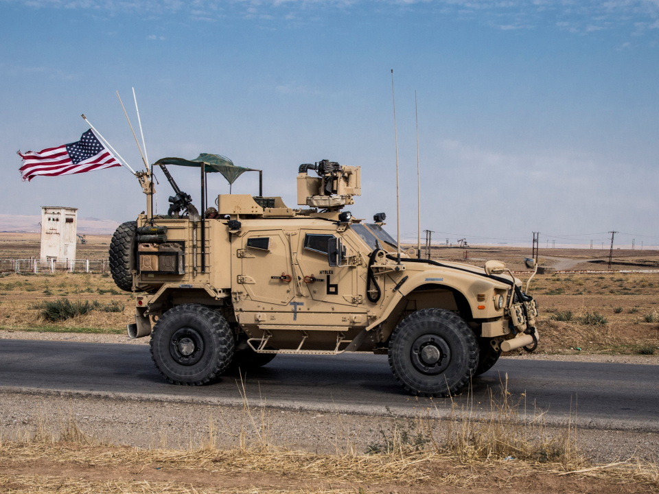 FILE - In this Monday, Oct. 28, 2019 file photo, U.S. forces patrol Syrian oil fields, in eastern Syria.President Donald Trump's decision to dispatch new U.S. forces to eastern Syria to secure oil fields is being criticized by some experts as ill-defined and ambiguous. But the residents of the area, one of the country's most remote and richest regions, hope the U.S. focus on eastern Syria would bring an economic boon and eliminate what remains of the Islamic State group. (AP Photo/Baderkhan Ahmad, File)