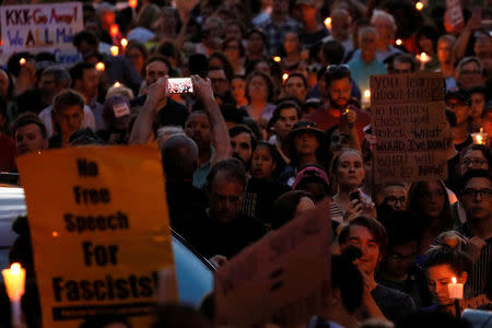 People gather for a vigil in response to the death of a counter-demonstrator at the "Unite the Right" rally in Charlottesville, in Washington, U.S. August 13, 2017. REUTERS/Jonathan Ernst