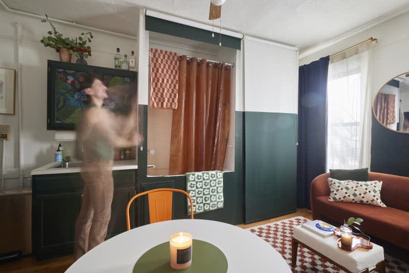 Dweller reveals bathing area in multi-use studio apartment.