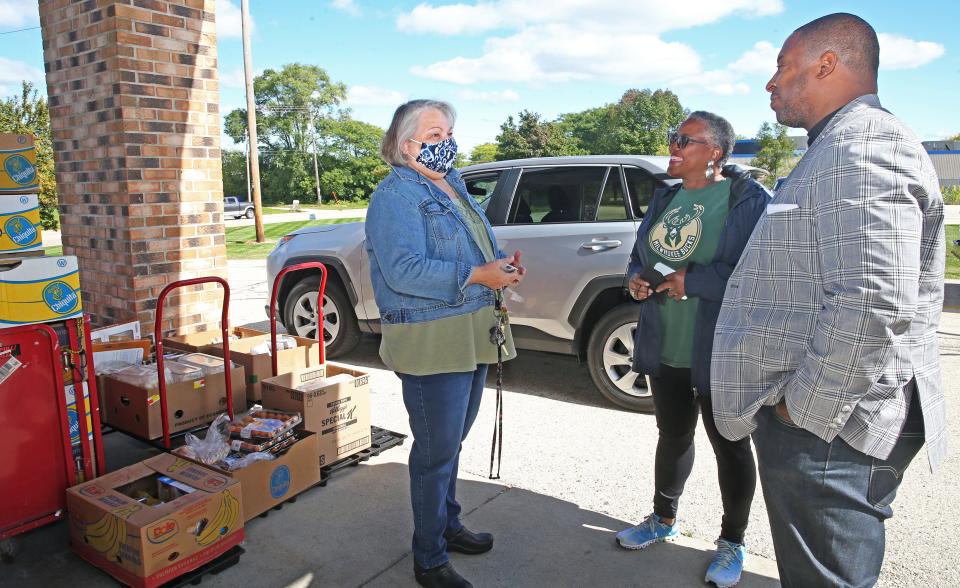 Julie Wagner, left, talks with Sharon Spencer, center and Rev. Christopher Boston, pastor of Lamb of God Missionary Baptist Church on Wednesday, Sept. 28, 2022. Wagner was picking up food for she and her family at the weekly Know Hunger No More, food distribution. “If I can save something here (food pantry), I can take care of something else,” she said.