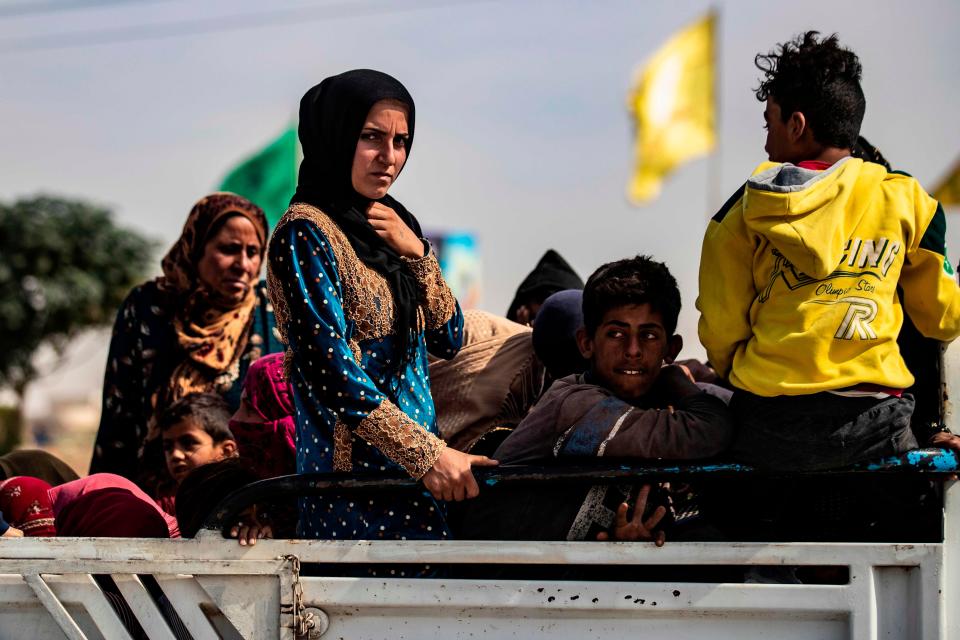 Arab and Kurdish civilians flee amid Turkey's military assault on Kurdish-controlled areas in northeastern Syria on Oct. 11.