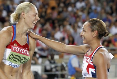 FILE PHOTO - Tatyana Chernova of Russia (L) celebrates winning the women's heptathlon with Jessica Ennis of Britain after their women's 800 metres event at the IAAF World Athletics Championships in Daegu, August 30, 2011. REUTERS/Phil Noble