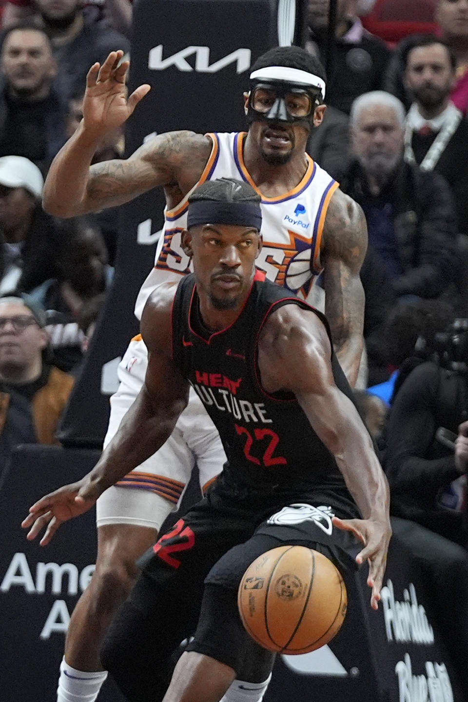 Miami Heat forward Jimmy Butler (22) looks for an opening past Phoenix Suns guard Bradley Beal during the first half of an NBA basketball game, Monday, Jan. 29, 2024, in Miami. (AP Photo/Wilfredo Lee)