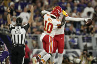 Kansas City Chiefs wide receiver Tyreek Hill (10) celebrates with teammate Demarcus Robinson after Robinson scored a touchdown in the first half of an NFL football game against the Baltimore Ravens, Sunday, Sept. 19, 2021, in Baltimore. (AP Photo/Julio Cortez)