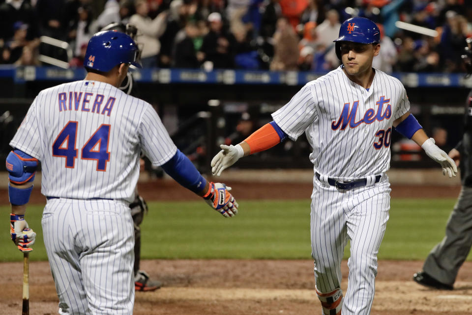 New York Mets' Michael Conforto (30) is greeted by Rene Rivera (44) after hitting a solo home run against the Miami Marlins during the sixth inning of a baseball game, Sunday, April 9, 2017, in New York. (AP Photo/Julie Jacobson)