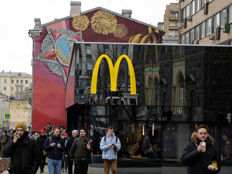 Men walk in front of the McDonald's flagship restaurant at Pushkinskaya Square in central Moscow on March 13, 2022, McDonald's last day in Russia.