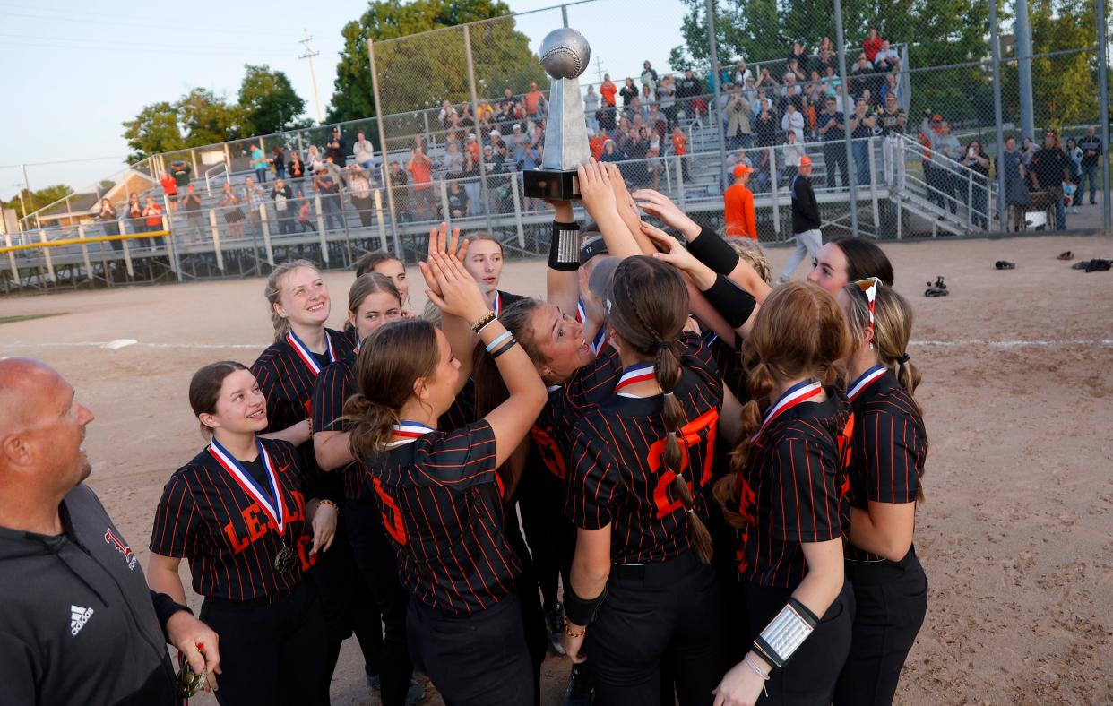Leslie players celebrate with their Softball Classic championship trophy after defeating DeWitt 7-1 on Friday, May 26, 2023, at Ranney Park.