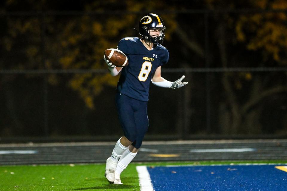 DeWitt's' Bryce Kurncz celebrates his touchdown against Cadillac during the first quarter on Friday, Oct. 28, 2022, at DeWitt High School.