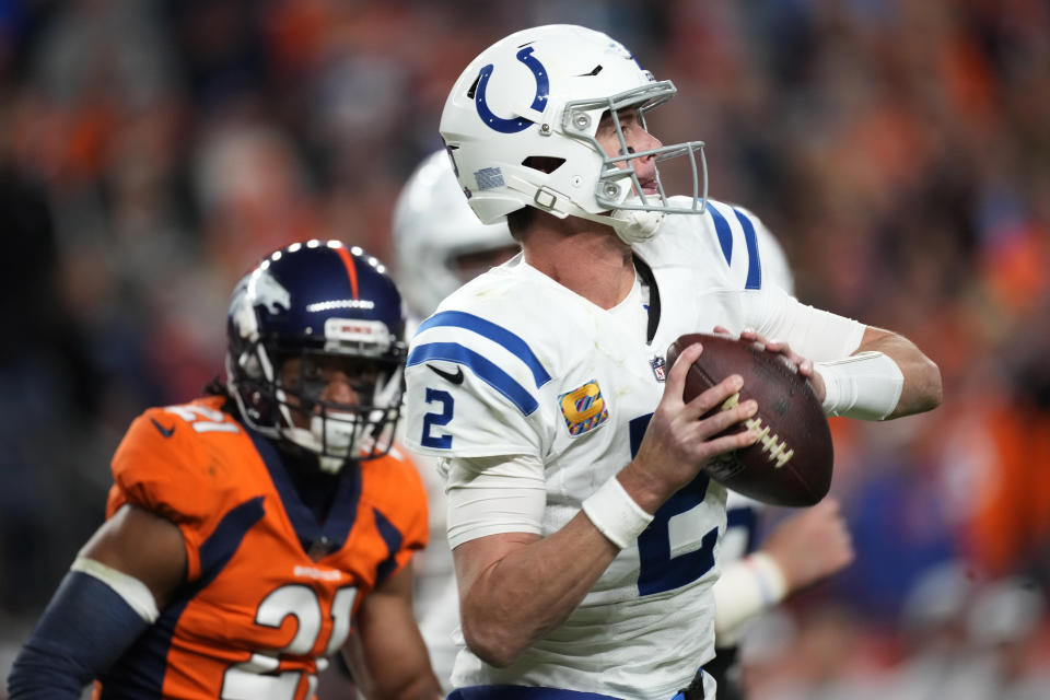 Indianapolis Colts quarterback Matt Ryan (2) looks to throw under pressure from Denver Broncos cornerback K'Waun Williams (21) during the second half of an NFL football game, Thursday, Oct. 6, 2022, in Denver. (AP Photo/David Zalubowski)