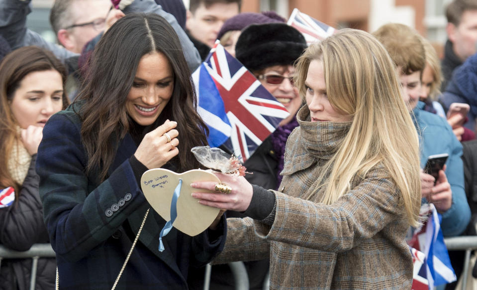 Amy Pickerill assisting Meghan Markle during a visit to Edinburgh Castle in February. [Photo: Getty]