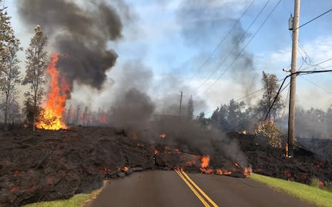 Lava from a fissure slowly advancing to the northeast on Hookapu Street in Leilani Estates, Hawaii - Credit: US Geological Survey/HO/AFP Photo