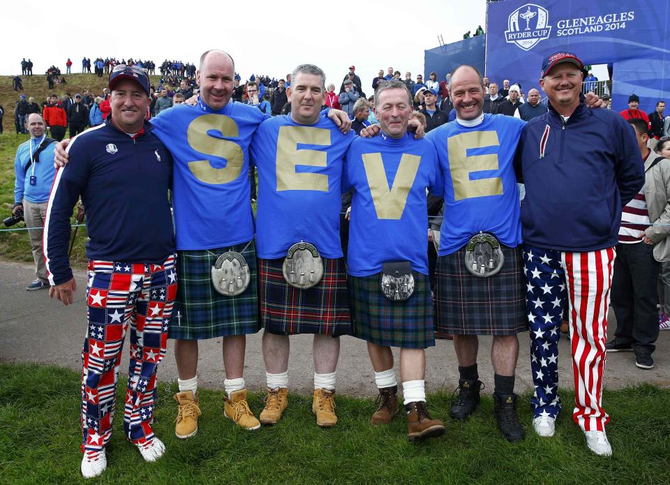 Spectators pose wearing tee shirts with the name "Seve" in memory to Seve Ballesteros, during practice ahead of the 2014 Ryder Cup at Gleneagles in Scotland September 25, 2014. REUTERS/Eddie Keogh (BRITAIN - Tags: SPORT GOLF)