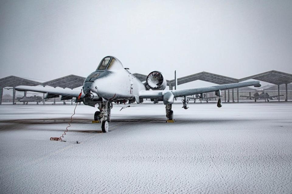 An aircraft is covered in snow