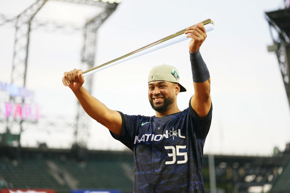 National League's Elias Díaz, of the Colorado Rockies, holds up his MVP trophy after the National League defeated the American League 3-2 in the MLB All-Star baseball game in Seattle, Tuesday, July 11, 2023. (AP Photo/Lindsey Wasson)