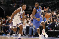 Dallas Mavericks forward Tim Hardaway Jr. (11) loses control of the ball, resulting in a turnover, as he is defended by Sacramento Kings guard Buddy Hield (24) during the first half of an NBA basketball game in Dallas, Sunday, Oct. 31, 2021. (AP Photo/Michael Ainsworth)