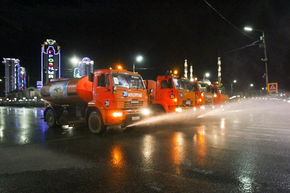 Municipal tankers spray disinfectant as a precaution against the coronavirus, on a street in the center of Grozny, Russia, Monday, April 6, 2020. Ramzan Kadyrov, strongman leader of Russia's province of Chechnya, has taken extreme measures to fight the spread of the new coronavirus in the region, vowing Monday not to let anyone who is not a formal resident of Chechnya into the area.The new coronavirus causes mild or moderate symptoms for most people, but for some, especially older adults and people with existing health problems, it can cause more severe illness or death. (AP Photo/Musa Sadulayev)