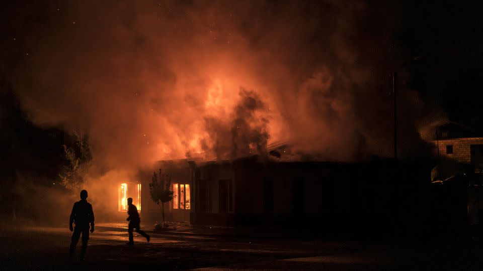 A fire burns in a hardware store after a rocket attack caused the building to catch fire on October 3, 2020 in Stepanakert, Nagorno-Karabakh.  - Brendan Hoffman/Getty Images