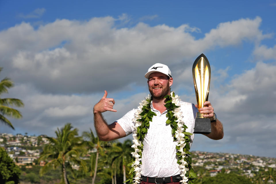 Grayson Murray holds the trophy after winning the Sony Open golf event, Sunday, Jan. 14, 2024, at Waialae Country Club in Honolulu. (AP Photo/Matt York)